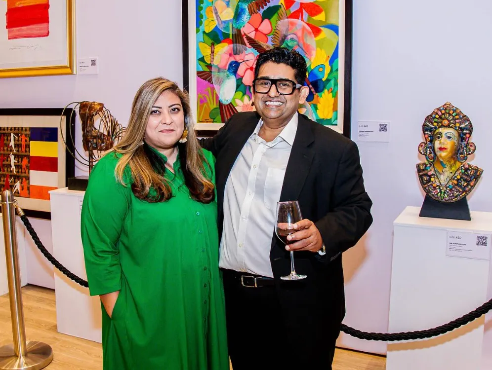 Malaka Talwatte at the auction preview, among framed works and a painted bust on plinths.