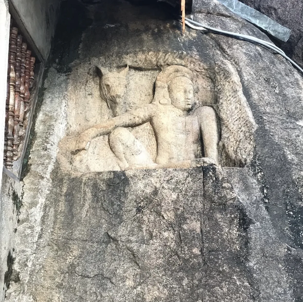 The Isurumuniya Man and Horse relief, a seated helmeted figure with a horse's head carved in the rock behind him.