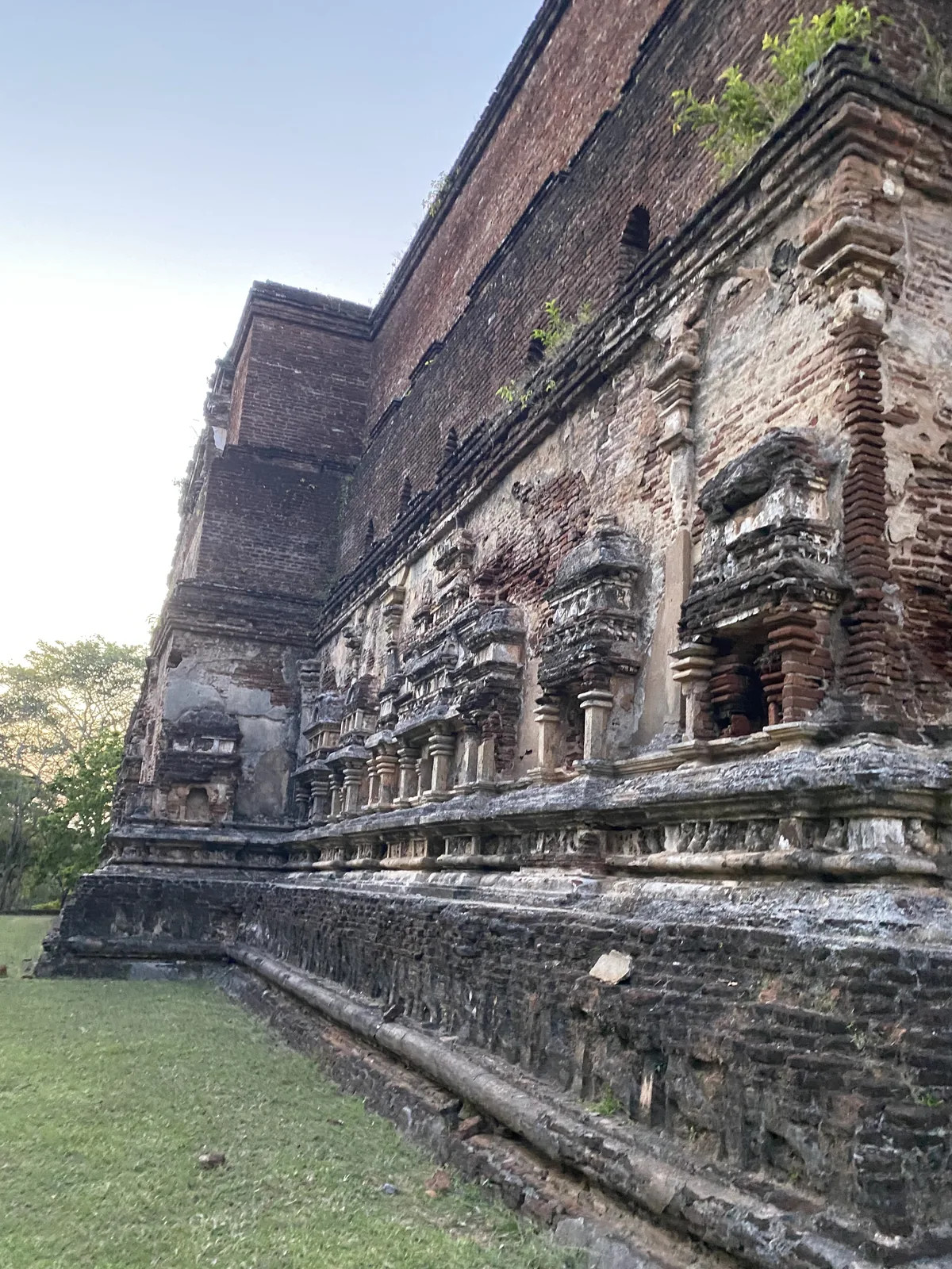 The exterior brick wall of the Lankatilaka image house, worked in tiers of pilastered false-storey niches imitating a many-storeyed mansion.
