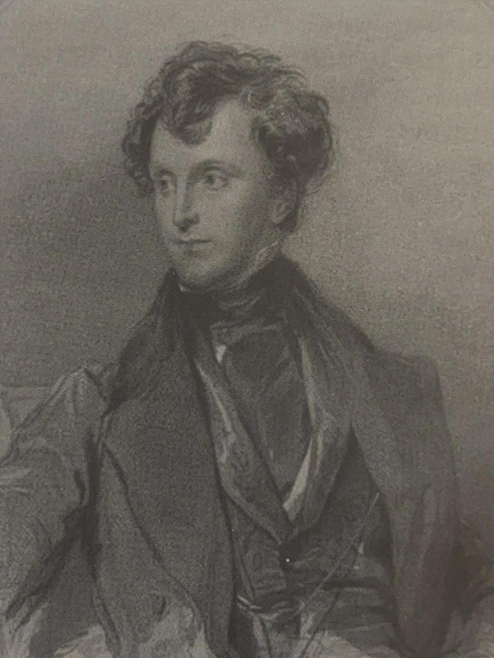 An engraved portrait of Sir James Emerson Tennent, a curly-haired man in a dark coat.