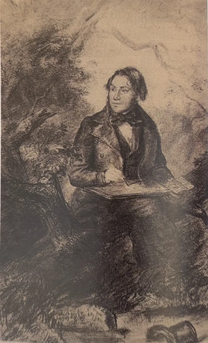A contemporary portrait of Andrew Nicholl seated outdoors with a drawing board on his lap.