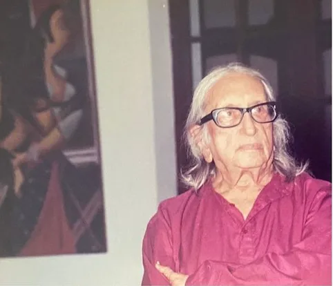 George Keyt standing before one of his paintings.