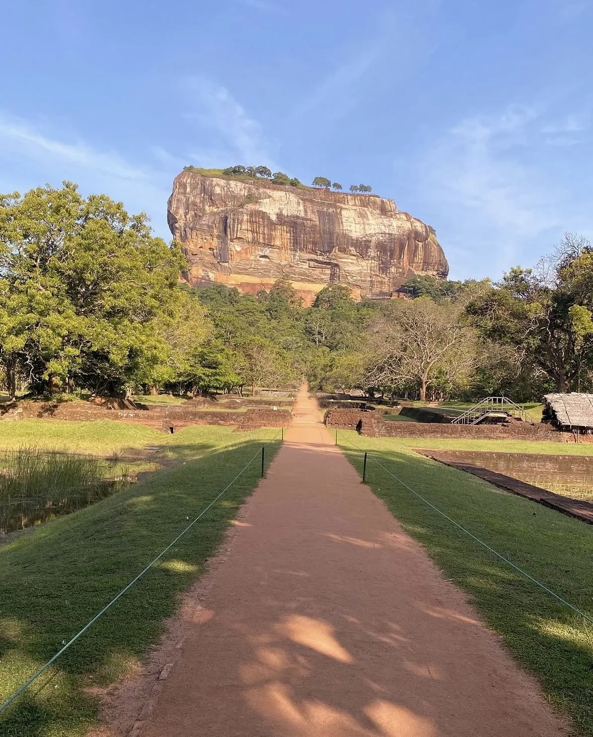 The rock of Sigiriya rising from the surrounding plain, seen from the approach.